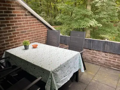 a table and two chairs on a balcony with a table and a plant at Hengelhoef Ceder 106 in Houthalen-Helchteren