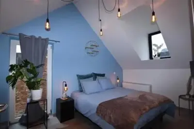 a bedroom with a large bed with a blue ceiling at B & B 't Pomphuys in Zoutleeuw