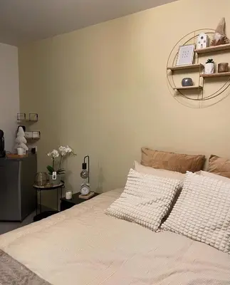 a bedroom with a bed and a shelf on the wall at B & B 't Pomphuys in Zoutleeuw