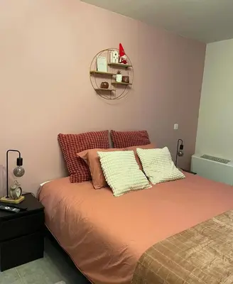 a bedroom with a bed with two pillows on it at B & B 't Pomphuys in Zoutleeuw