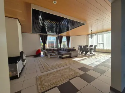 a living room with a couch and a table at Afgelegen woning met buitenjacuzzi en vergaderruimte ! in Pelt