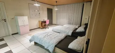 a room with two beds and a refrigerator at Afgelegen woning met buitenjacuzzi en vergaderruimte ! in Pelt