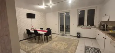 a kitchen and dining room with a table and chairs at Afgelegen woning met buitenjacuzzi en vergaderruimte ! in Pelt