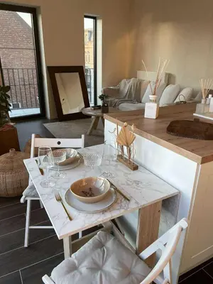 a dining room with a table with plates and wine glasses at Casa Lariz in Hasselt