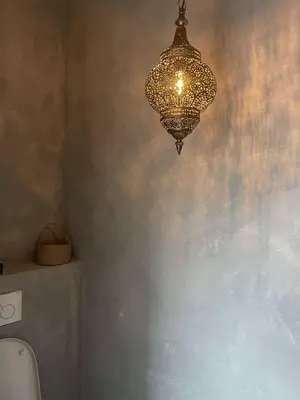 a chandelier hanging from the ceiling in a bathroom at Casa Lariz in Hasselt
