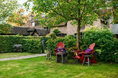 two chairs and a table in a yard at Het Zwart Schaap in Pelt