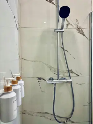 a bathroom with a shower and two toilets at Appartement cosy à Liège in Liège