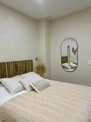 a bedroom with a bed with a mirror on the wall at Appartement cosy à Liège in Liège