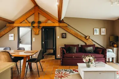 a living room with a couch and a table at L'Air du Pré by WelcHome in Verviers