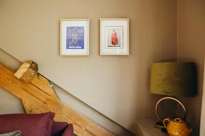 a staircase with three pictures on the wall and a lamp at L'Air du Pré by WelcHome in Verviers