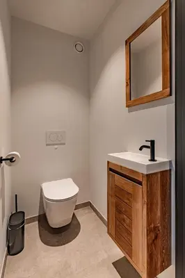 a bathroom with a toilet and a sink and a mirror at Villa Victoire in Heers