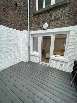 a wooden deck on the side of a building at Magnifique appartement 1 chambre in Liège