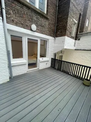 a large wooden deck in front of a building at Magnifique appartement 1 chambre in Liège