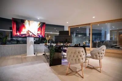 a living room with two chairs and a flat screen tv at Dream Saint Lambert in Liège
