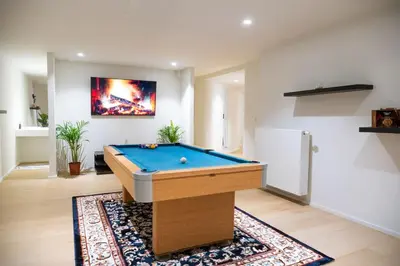 a living room with a pool table on a rug at Dream Saint Lambert in Liège