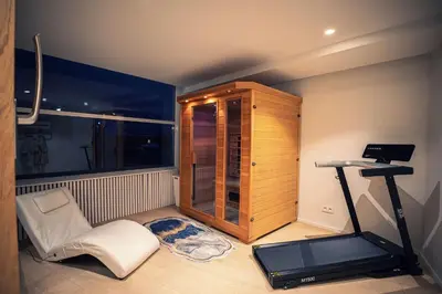 a room with a treadmill and a chair and a room with a window at Dream Saint Lambert in Liège