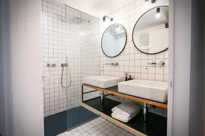a bathroom with two sinks and a mirror at Dream Saint Lambert in Liège