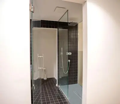 a bathroom with a shower with a glass door at Dream Saint Lambert in Liège