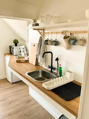 a kitchen with a sink and a counter top at Chambre et salle de bain privative in Liège