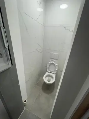 a bathroom with a white toilet in a stall at Sterna in Liège