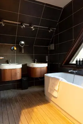 a bathroom with two sinks and a bath tub at Broekemmolen - Nature getaway & green spot in Bilzen