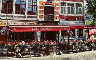 a group of people sitting outside of a restaurant at Appartement 002 au rez-de-chaussée avant in Angleur