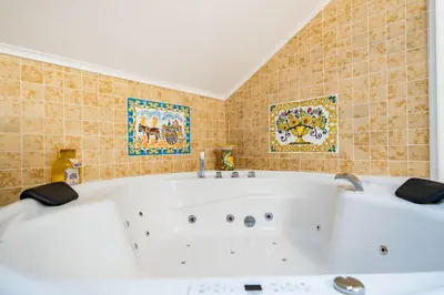 a white bath tub in a bathroom with tiles at Loft36 in Herstal
