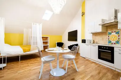a kitchen with a table and two chairs in a room at Loft36 in Herstal