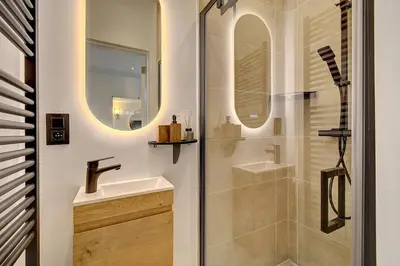a bathroom with a sink and a shower at - Suite Solvay - Cosy & Modern Flat in Liège