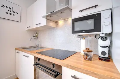 a kitchen with a sink and a microwave at - Suite Solvay - Cosy & Modern Flat in Liège