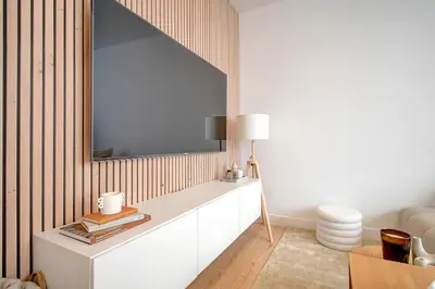 a living room with a large mirror on the wall at - Suite Solvay - Cosy & Modern Flat in Liège