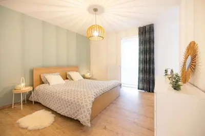 a bedroom with a bed and a chandelier at Miracle Luxury Property Liège Guillemins in Liège