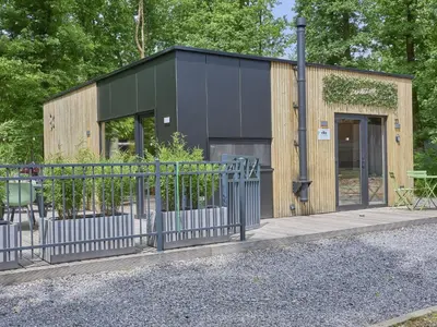 a small building with a fence in front of it at Zen en Zoet in Zutendaal