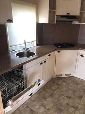 a kitchen with a sink and an empty dishwasher at Chalet nr 17 Park Bergzicht Teuven in Voeren