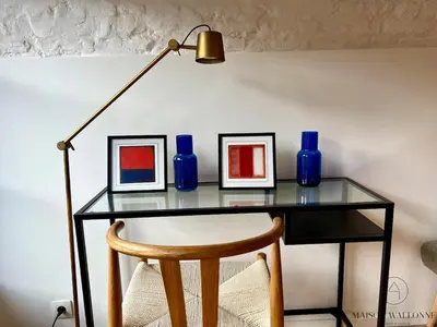 a glass table with three blue vases and a lamp at L'Atelier Triplex - Architect's apartment in Liège