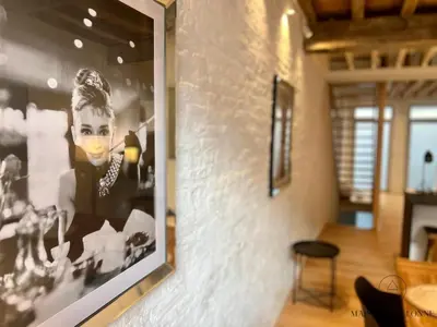 a framed picture of a woman on a wall at L'Atelier Triplex - Architect's apartment in Liège
