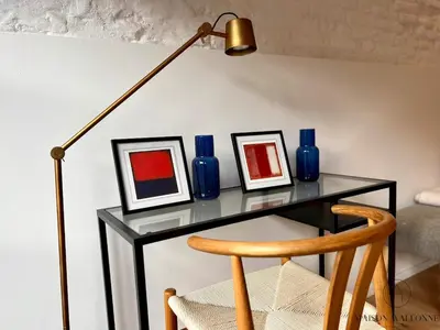 a glass table with three blue vases and a lamp at L'Atelier Triplex - Architect's apartment in Liège