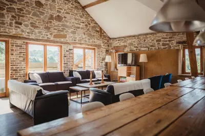 a room with chairs and a large wooden table at La Bushaye in Aubel