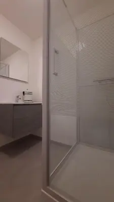 a glass shower in a bathroom with a sink at Chambre d'hôte, la rouge in Liège