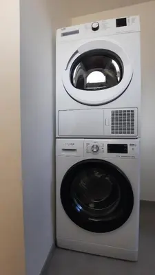a washing machine and a dryer in a room at Chambres d'hôte, la grise in Liège