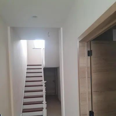 a staircase leading up to a room with white walls at RELAX Room in Chaudfontaine