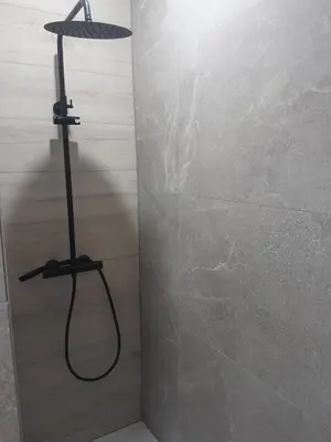 a shower in a bathroom with a shower head at RELAX Room in Chaudfontaine