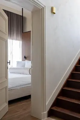 a stairway leading to a bedroom with a bed at Pastorij Huys in Heers