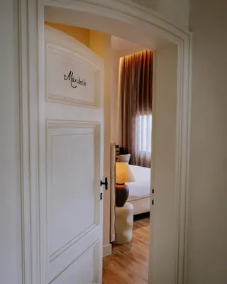 a door leading into a bedroom with a bed at Pastorij Huys in Heers