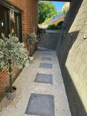 a walkway with a potted plant next to a building at Quiet villa Exceptional view and its exterior in Liège