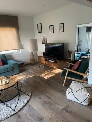 a living room with a flat screen tv and a couch at Quiet villa Exceptional view and its exterior in Liège