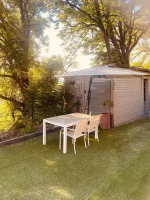 a table and chairs under an umbrella in a yard at Quiet villa Exceptional view and its exterior in Liège