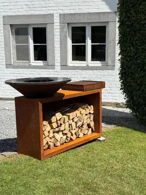 a fire pit with a pile of fire wood at La Perle du Fierain in Wegnez