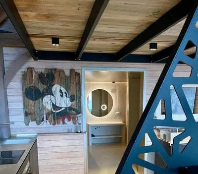 a staircase in a house with a painting on the wall at La Perle du Fierain in Wegnez