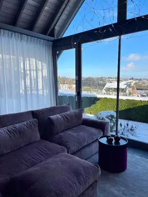 a living room with a couch and a large window at La Perle du Fierain in Wegnez